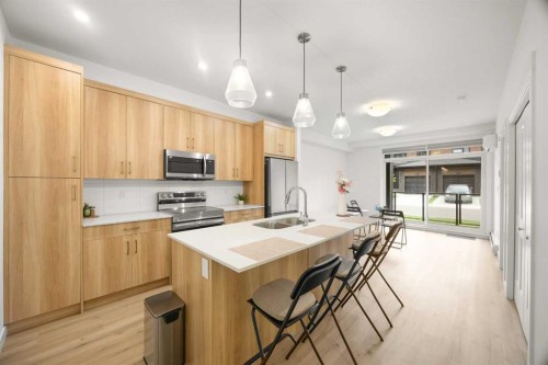 2104-55 Lucas Way Nw, Calgary, AB - Indoor Photo Showing Kitchen With Stainless Steel Kitchen With Double Sink With Upgraded Kitchen