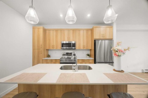 2104-55 Lucas Way Nw, Calgary, AB - Indoor Photo Showing Kitchen With Stainless Steel Kitchen With Double Sink With Upgraded Kitchen
