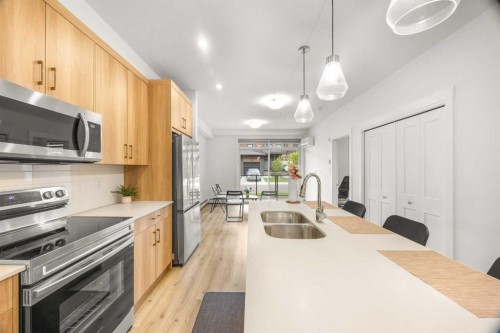 2104-55 Lucas Way Nw, Calgary, AB - Indoor Photo Showing Kitchen With Stainless Steel Kitchen With Double Sink With Upgraded Kitchen
