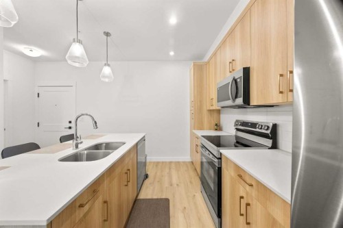 2104-55 Lucas Way Nw, Calgary, AB - Indoor Photo Showing Kitchen With Stainless Steel Kitchen With Double Sink With Upgraded Kitchen