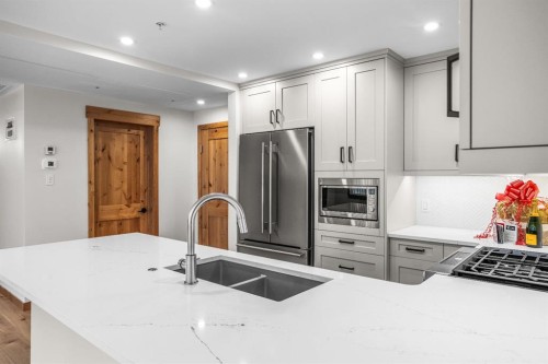 108-1606 Spring Creek Gate, Canmore, AB - Indoor Photo Showing Kitchen With Double Sink With Upgraded Kitchen