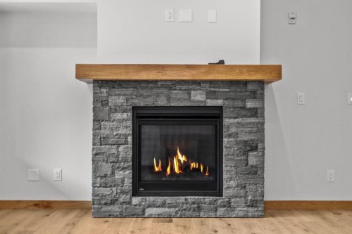 108-1606 Spring Creek Gate, Canmore, AB - Indoor Photo Showing Living Room With Fireplace