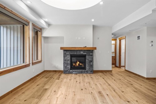 108-1606 Spring Creek Gate, Canmore, AB - Indoor Photo Showing Living Room With Fireplace