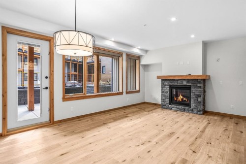 108-1606 Spring Creek Gate, Canmore, AB - Indoor Photo Showing Living Room With Fireplace