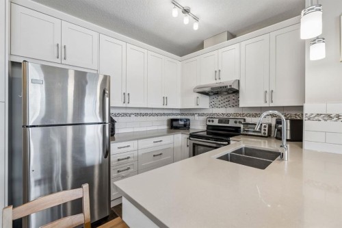 1403-450 Sage Valley Drive Nw, Calgary, AB - Indoor Photo Showing Kitchen With Stainless Steel Kitchen With Double Sink With Upgraded Kitchen