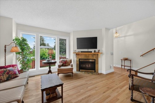 2511 Exshaw Road Nw, Calgary, AB - Indoor Photo Showing Living Room With Fireplace
