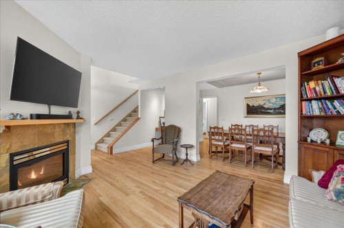 2511 Exshaw Road Nw, Calgary, AB - Indoor Photo Showing Living Room With Fireplace