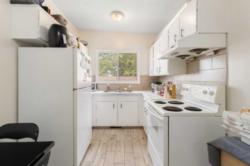 11268 6 Sw, Calgary, AB - Indoor Photo Showing Kitchen With Double Sink