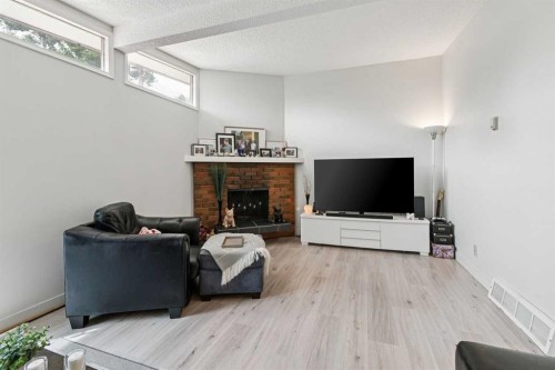715 5 Street Ne, Calgary, AB - Indoor Photo Showing Other Room With Fireplace