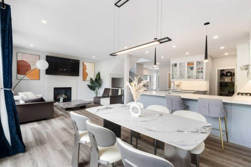 100 Crestbrook View Sw, Calgary, AB - Indoor Photo Showing Dining Room With Fireplace
