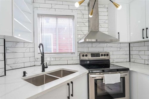 18 Falmere Way Ne, Calgary, AB - Indoor Photo Showing Kitchen With Double Sink
