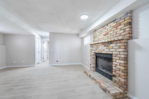 18 Falmere Way Ne, Calgary, AB - Indoor Photo Showing Other Room With Fireplace