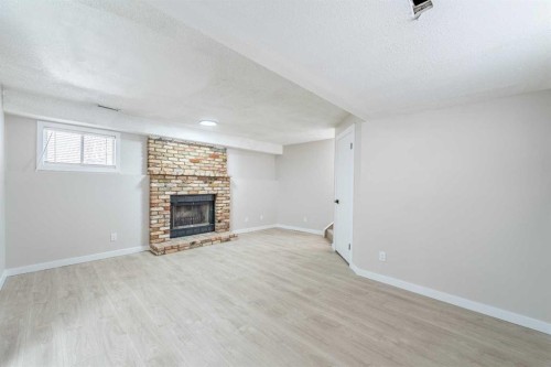 18 Falmere Way Ne, Calgary, AB - Indoor With Fireplace