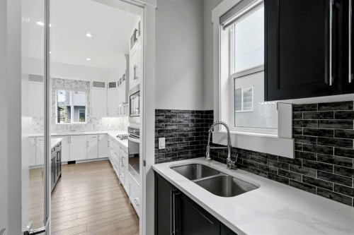 111 Kinniburgh Place, Chestermere, AB - Indoor Photo Showing Kitchen With Double Sink With Upgraded Kitchen