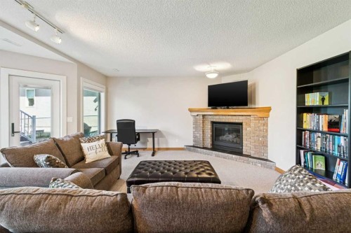 22 Patrick View Sw, Calgary, AB - Indoor Photo Showing Living Room With Fireplace