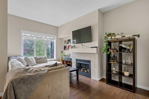 72 Copperpond Landing Se, Calgary, AB - Indoor Photo Showing Living Room With Fireplace