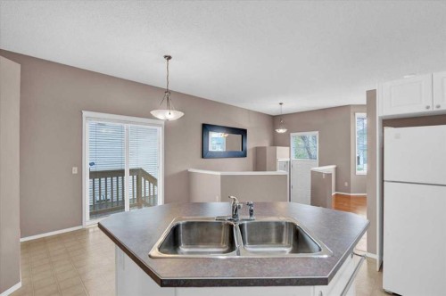 231 Tuscany Drive Nw, Calgary, AB - Indoor Photo Showing Kitchen With Double Sink
