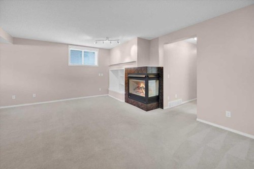 231 Tuscany Drive Nw, Calgary, AB - Indoor Photo Showing Other Room With Fireplace