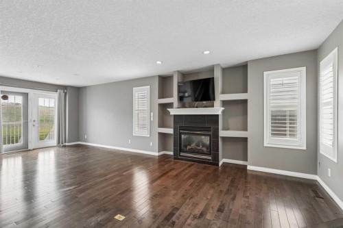 139 Hidden Creek Gardens Nw, Calgary, AB - Indoor Photo Showing Living Room With Fireplace