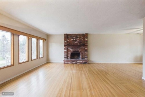 5 Chisholm Crescent Nw, Calgary, AB - Indoor Photo Showing Living Room With Fireplace