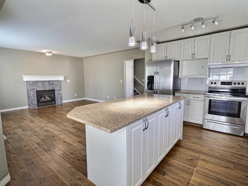 185 Tuscarora Close Nw, Calgary, AB - Indoor Photo Showing Kitchen With Fireplace With Upgraded Kitchen