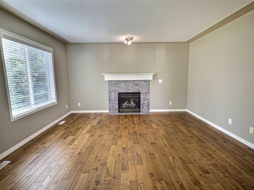 185 Tuscarora Close Nw, Calgary, AB - Indoor Photo Showing Living Room With Fireplace