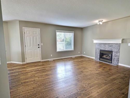 185 Tuscarora Close Nw, Calgary, AB - Indoor Photo Showing Living Room With Fireplace