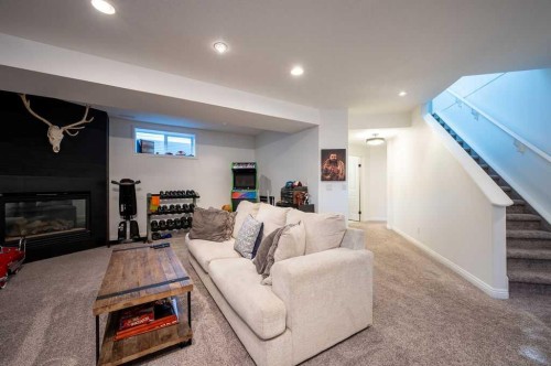 98 Chapala Grove Se, Calgary, AB - Indoor Photo Showing Basement With Fireplace