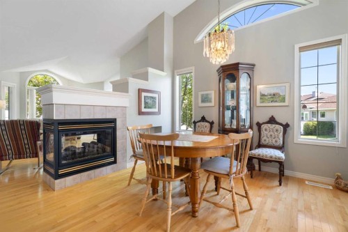 71 Scotia Landing Nw, Calgary, AB - Indoor Photo Showing Dining Room With Fireplace