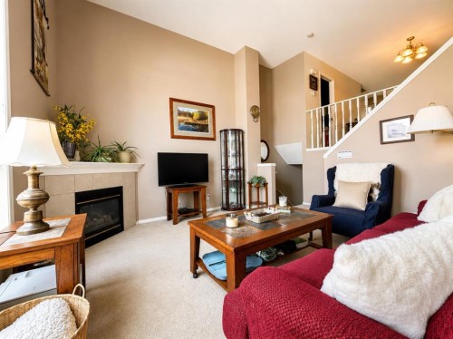 122 Bridlewood Lane Sw, Calgary, AB - Indoor Photo Showing Living Room With Fireplace