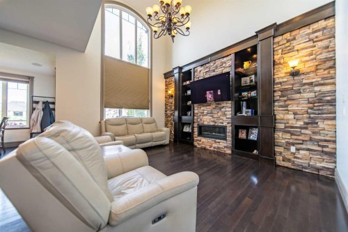 1109 Coopers Drive Sw, Airdrie, AB - Indoor Photo Showing Living Room With Fireplace