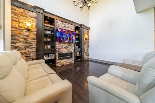 1109 Coopers Drive Sw, Airdrie, AB - Indoor Photo Showing Living Room With Fireplace
