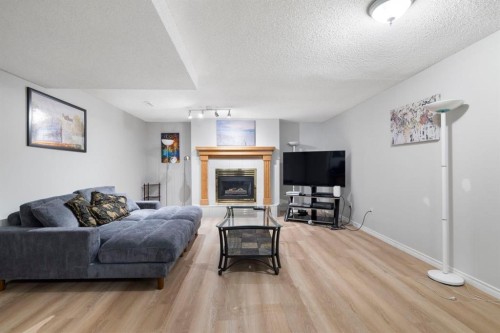 76 Douglas Ridge Close Se, Calgary, AB - Indoor Photo Showing Living Room With Fireplace