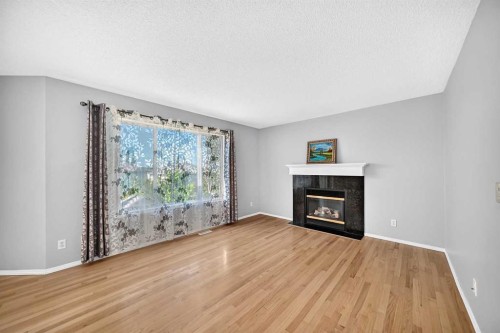 65 Tuscarora Place Nw, Calgary, AB - Indoor Photo Showing Living Room With Fireplace