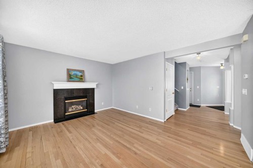 65 Tuscarora Place Nw, Calgary, AB - Indoor Photo Showing Living Room With Fireplace