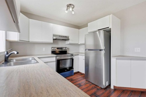 129 Hidden Spring Circle Nw, Calgary, AB - Indoor Photo Showing Kitchen With Double Sink