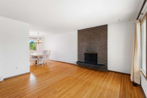 6008 Dalgetty Drive Nw, Calgary, AB - Indoor Photo Showing Living Room With Fireplace