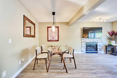 193 Patina Park Sw, Calgary, AB - Indoor Photo Showing Dining Room With Fireplace