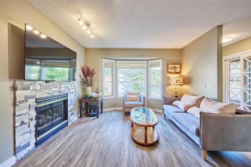 193 Patina Park Sw, Calgary, AB - Indoor Photo Showing Living Room With Fireplace