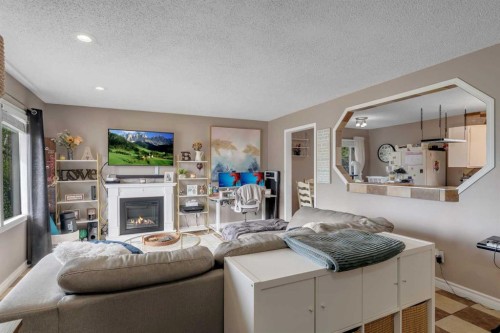 112 Penmeadows Close Se, Calgary, AB - Indoor Photo Showing Living Room With Fireplace