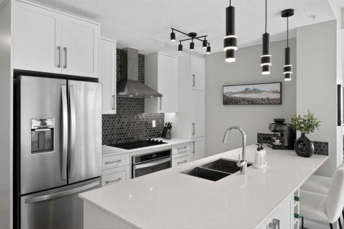 302-2231 Mahogany Boulevard Se, Calgary, AB - Indoor Photo Showing Kitchen With Double Sink With Upgraded Kitchen