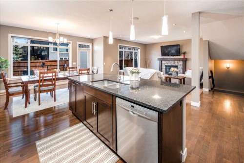10 Aspenshire Place Sw, Calgary, AB - Indoor Photo Showing Kitchen With Fireplace With Double Sink