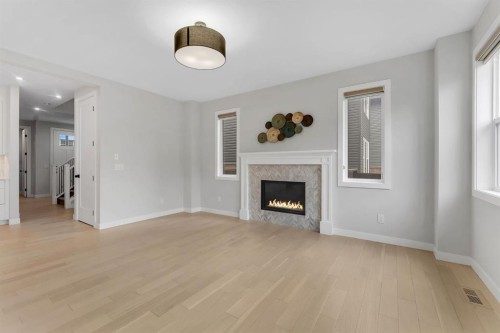 45 Carringsby Landing Nw, Calgary, AB - Indoor Photo Showing Living Room With Fireplace