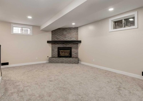 7956 71 Avenue Nw, Calgary, AB - Indoor Photo Showing Basement With Fireplace