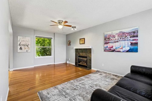 10433 Hidden Valley Drive Nw, Calgary, AB - Indoor Photo Showing Living Room With Fireplace