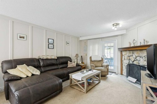 323 Ranchview Place Nw, Calgary, AB - Indoor Photo Showing Living Room With Fireplace