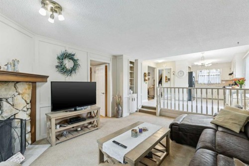 323 Ranchview Place Nw, Calgary, AB - Indoor Photo Showing Living Room With Fireplace