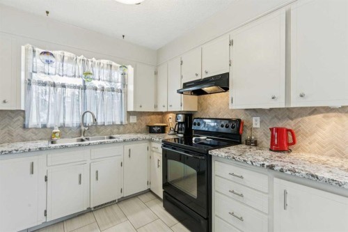 323 Ranchview Place Nw, Calgary, AB - Indoor Photo Showing Kitchen With Double Sink