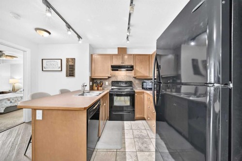 208-30 Cranfield Link Se, Calgary, AB - Indoor Photo Showing Kitchen With Double Sink