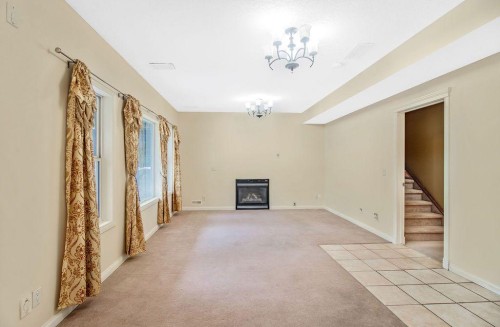 21 Royal Ridge Hill Nw, Calgary, AB - Indoor Photo Showing Other Room With Fireplace